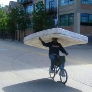 guy on bike with mattress , funny